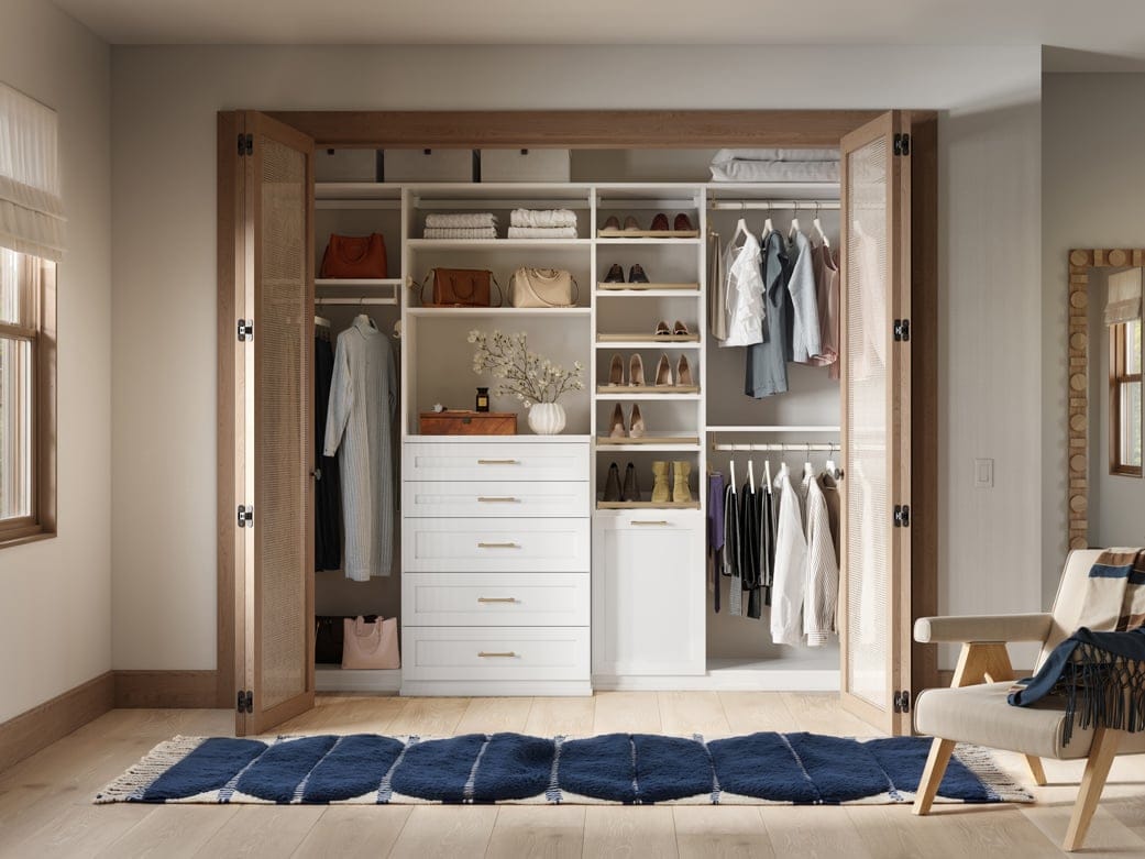 Light-toned reach in with counter space, drawers and integrated hamper by California Closets