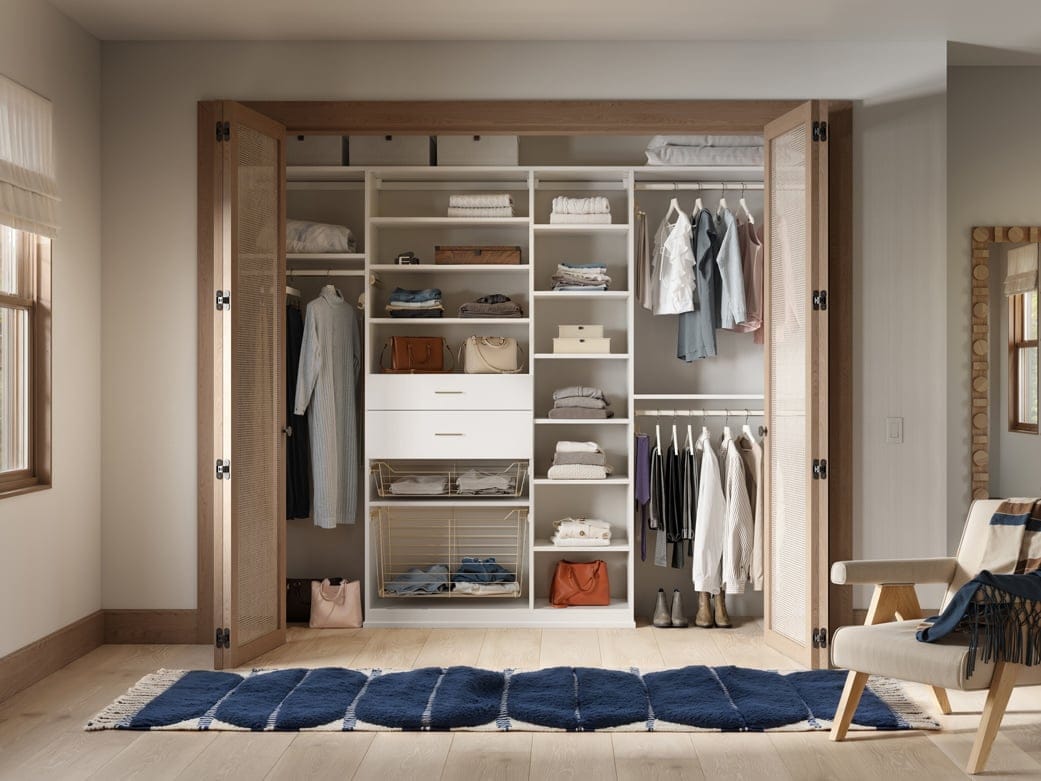 Reach in with counter space and hanging area, drawers, and open shelving by California Closets